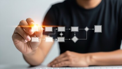 Person drawing a digital flowchart on a transparent screen with glowing connections