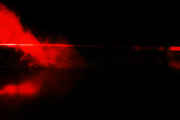 Red smoke over black studio background. Red steam on a black background. Copy space.
