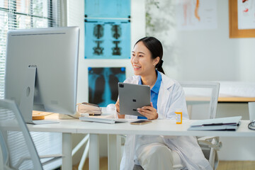 Asian female doctor consultation or tell patients the results of examinations by mobile phone and...