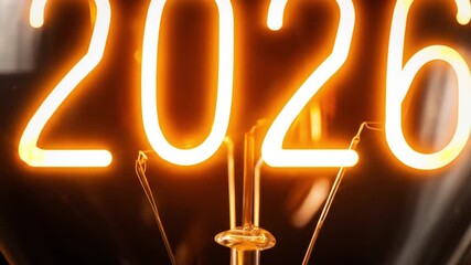 Close-up of glowing orange 2026 neon numerals over a warm filament bulb, futuristic glow, amber hue - Powered by Adobe