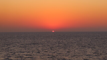 Fototapeta premium Beautiful Sunrise Appearing on the Ocean Horizon Viewed from Ferry Deck