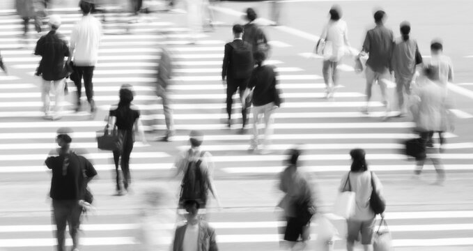 people crossing a busy city street, symbolizing urban energy, connection, and the pace of modern life.	