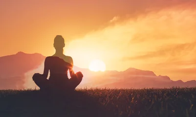 Fotobehang Rustgevend Woman Meditating at Sunrise in Nature – Peaceful Yoga Silhouette and Mindfulness Scene  © kieferpix