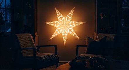 A large, glowing star-shaped lantern illuminates a cozy living room with two armchairs, creating a warm ambiance.