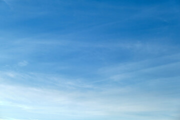 Clear blue sky with soft white clouds. Bright blue sky with gentle white clouds creating a calm and peaceful atmosphere, perfect for backgrounds, design projects, and relaxation themes.
