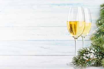 Champagne glasses and snowy fir