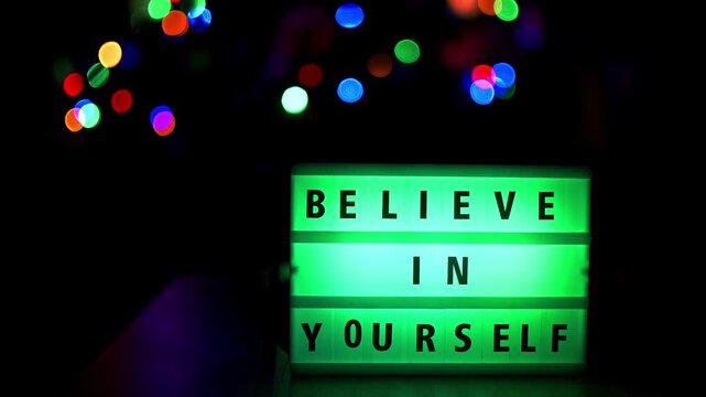 Believe in yourself quote written on a led light display with color changing. Static shot footage , nice soft background.