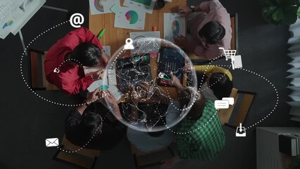 A dynamic office scene showcasing a team collaborating over charts and digital tools, emphasizing the importance of technology and teamwork in business strategies. Raster - Powered by Adobe