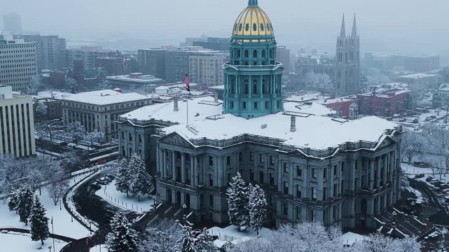 Denver Capitol in snow, wide aerial video, rotation, Denver, CO 4K
