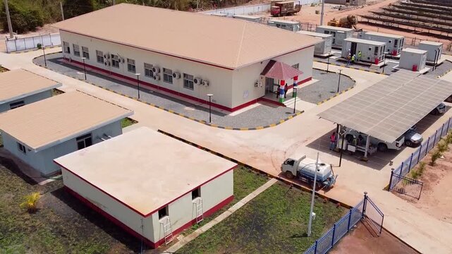 Aerial overview of Jambur Solar Plant control building area showing solar car shed, BESS, water tanks, service buildings, etc
