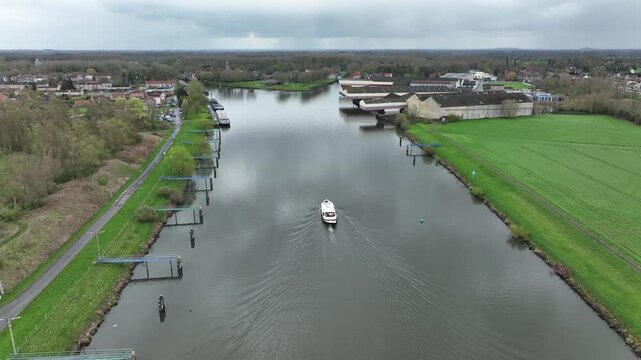 The Luxemotor  Boat moving along the canal in Strepy Thieu during a semi orbit shot on a cloudy day