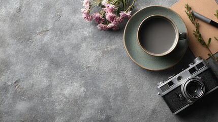 A camera, a cup of coffee, and a pen arranged on a serene workspace emphasizing creativity and inspiration