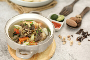 Indonesian Oxtail Soup Sop Buntut Served in Bowl with Vegetables and Spices