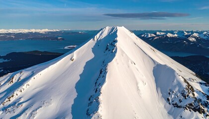 Snow-covered mountain peak aerial view