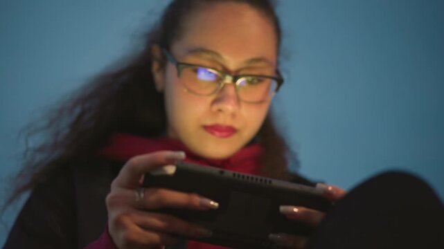 Female Coder Testing, Female Software Engineer Analyzing Mobile App Display Late At Night, Young Woman Programmer Testing Application Interface On Portable Device With Reflected Light At Night