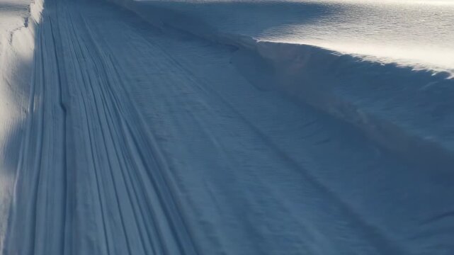 White Snow Texture with Tire Tracks in Sunlight Winter Scene