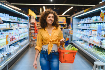 Woman shopping for healthy food in supermarket aisle
