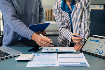 Business team working on a project in the office or reviewing and discussing a business project.