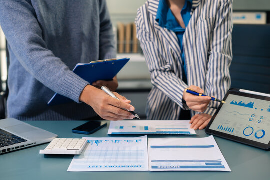 Business team working on a project in the office or reviewing and discussing a business project. - Powered by Adobe