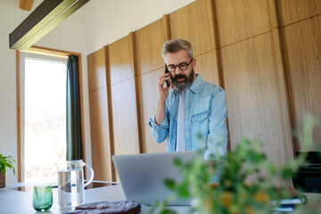Man working from home while on phone call.
