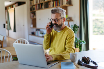 Man working from home while on phone call.