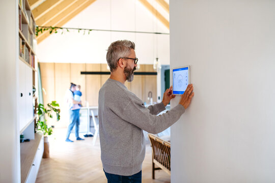 Man using smart home control panel.
