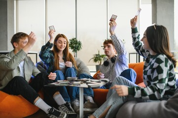 Happy friends playing board game at home