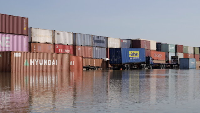 Shipping Containers and Trucks Partially Submerged by High Water