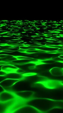 Abstract motion background with dynamic rippling green liquid light and dark shadows creating mesmerizing water surface pattern effect.