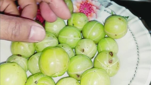 fresh indian gooseberries showcased on decorative plate in detailed closeup