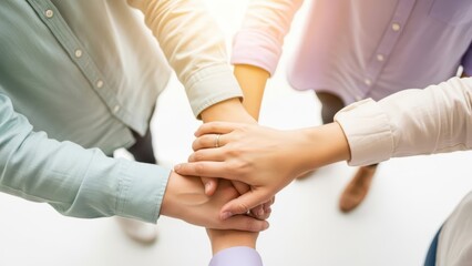 A group of diverse hands gently cupping a small, healthy plant with fresh green leaves, rooted in a mound of earthy soil, symbolizing teamwork and growth