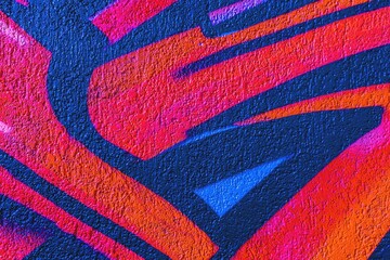 Graffiti art in bright orange, blue, red with textured surface. 90s urban style, vibrant colors, dynamic lines. Street art, murals, modern 90s, urban visuals, creative design. © Aleksandra Konoplya