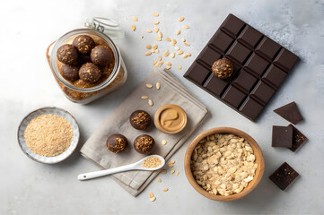 Wholesome Treats: An enticing arrangement of homemade energy balls, decadent dark chocolate, and other healthy ingredients tempts the senses, evoking a feeling of well-being and satisfaction. 