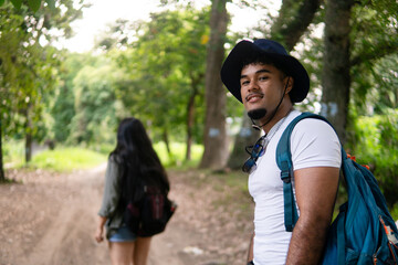 Adventurous couple hiking path exploring lush nature