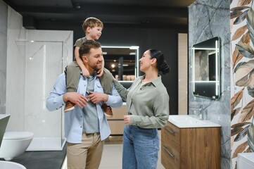 Fototapeta premium Family choosing bathroom fixtures in plumbing store