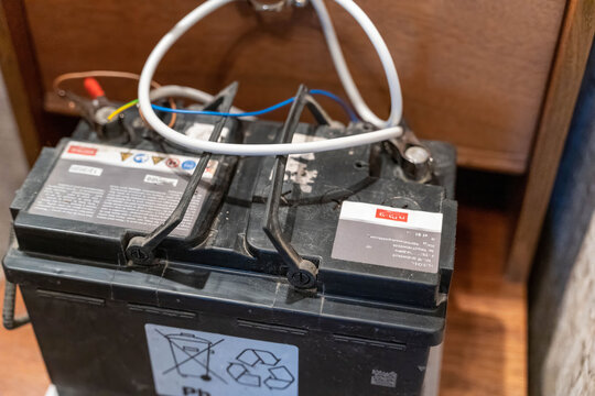 Old lead acid battery stored in a wooden cabinet at a workshop location - Powered by Adobe