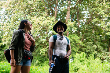 Happy couple enjoying nature walk in forest