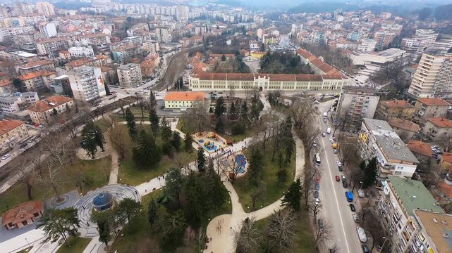 High-altitude drone video of Pleven&rsquo;s center on Bulgaria&rsquo;s Third of March National Day, showing the city square, the City Garden, and the Regional History Museum, Pleven, BG, 03 March 2019
