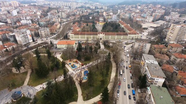 High-altitude drone video of Pleven&rsquo;s center on Bulgaria&rsquo;s Third of March National Day, showing the city square, the City Garden, and the Regional History Museum, Pleven, BG, 03 March 2019