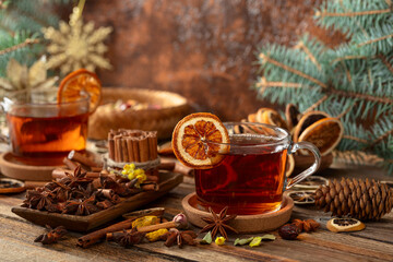 Christmas herbal tea with ingredients on a old wooden table.