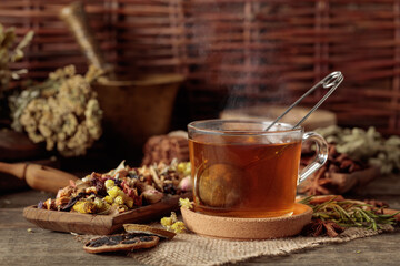 Cup of herbal tea with various dried herbs, flowers, and spices.