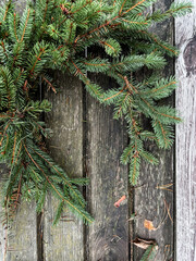 Making rustic Christmas wreath. Moody Christmas image, holiday preparations. High quality photo