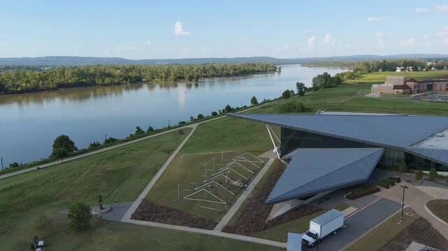 Drone ascending of museum building near river surrounded by park, United States Marshals Museum