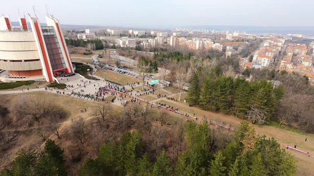 Aerial footage of the Pleven Panorama on Third of March 2019. Visitors gather in Skobelev Park, paying tribute and carrying a 740-meter Bulgarian flag, BG, EU, 03 March 2019