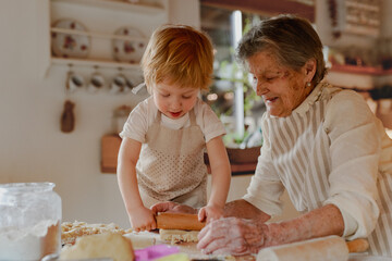 Family holiday baking with grandma in cozy kitchen.