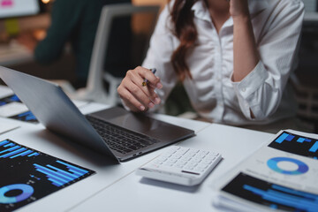 Businesswoman analyzing financial data on laptop planning strategy