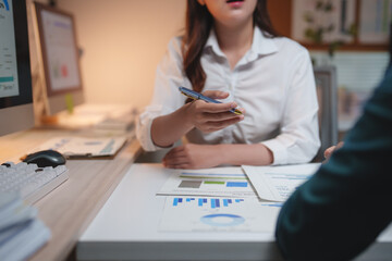 Business professional discussing financial data during office meeting
