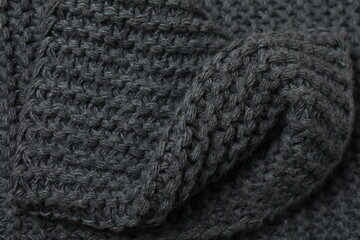 Fototapeta premium Texture of gray knitted fabric. Macro photography of natural wool background. 