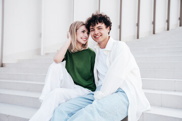 Smiling beautiful woman and her handsome boyfriend. Couple in casual summer clothes. Happy cheerful...