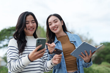Young asian women online shopping using smartphone and credit card